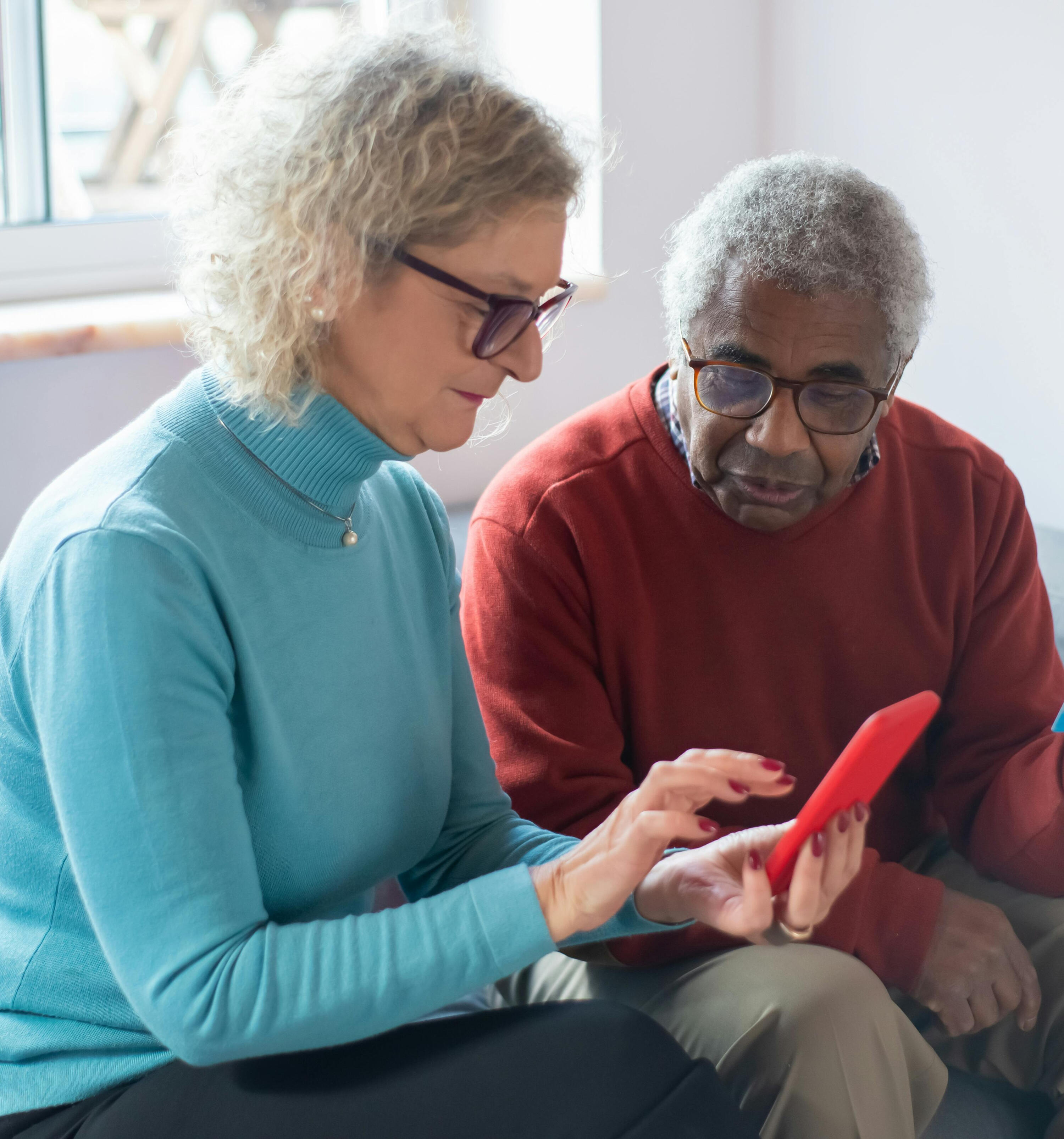 Two people looking at a phone